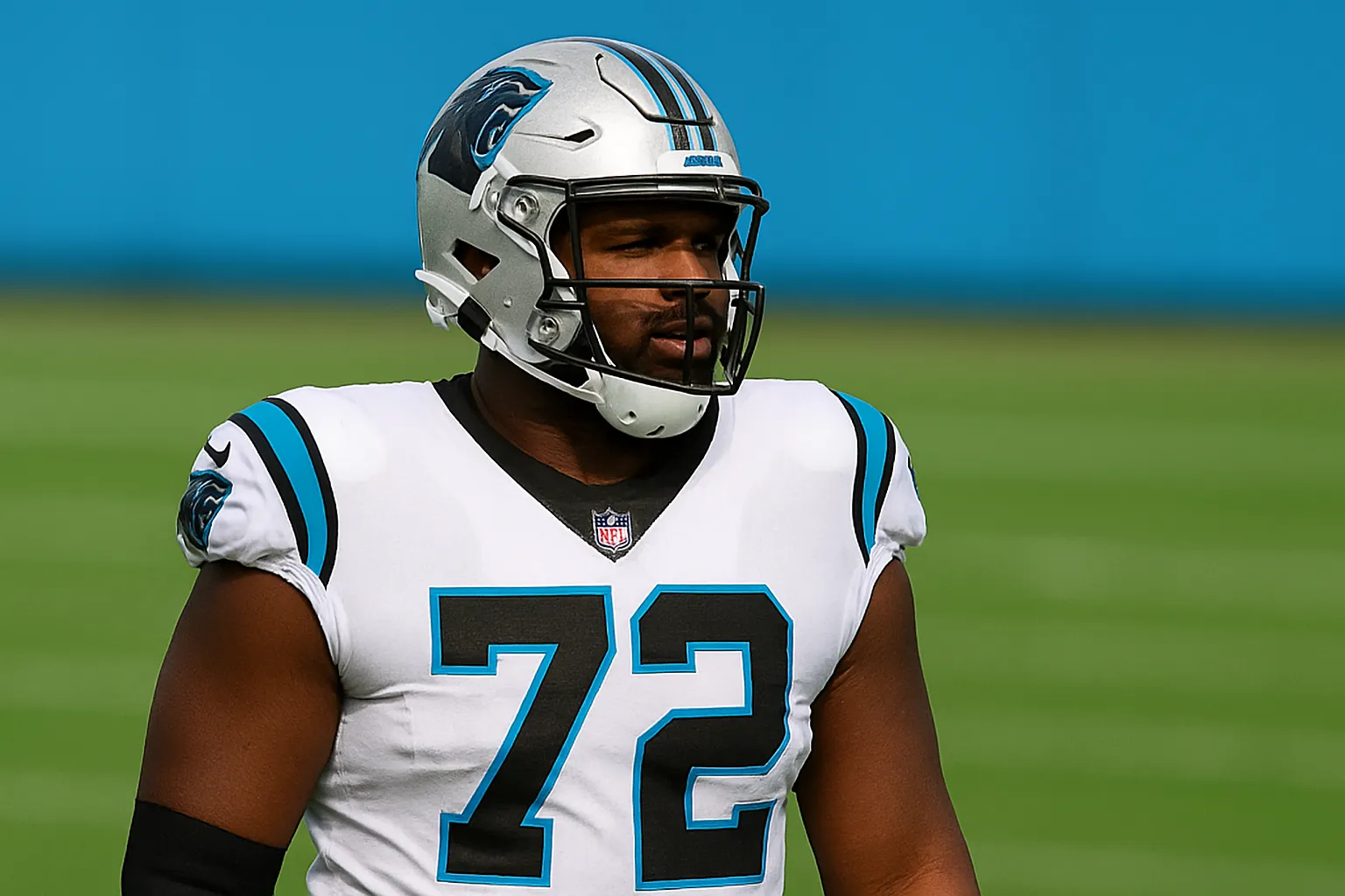 Carolina Panthers offensive lineman Taylor Moton wearing jersey number 72, standing on the football field in full uniform with a silver helmet and white jersey during a game or practice.